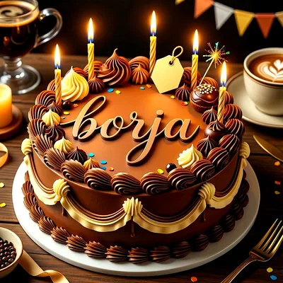 Tarta de cumpleaños de chocolate con velas encendidas, rosetones de nata y el nombre Borja escrito en la parte superior.
